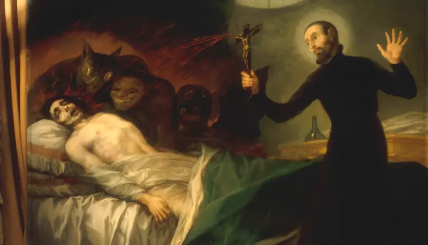 Ein Priester hält ein Kruzifix, um Dämonen von einem kranken Mann fernzuhalten. Dies zeigt, was ist Exorzismus: ein Kampf gegen das Böse.