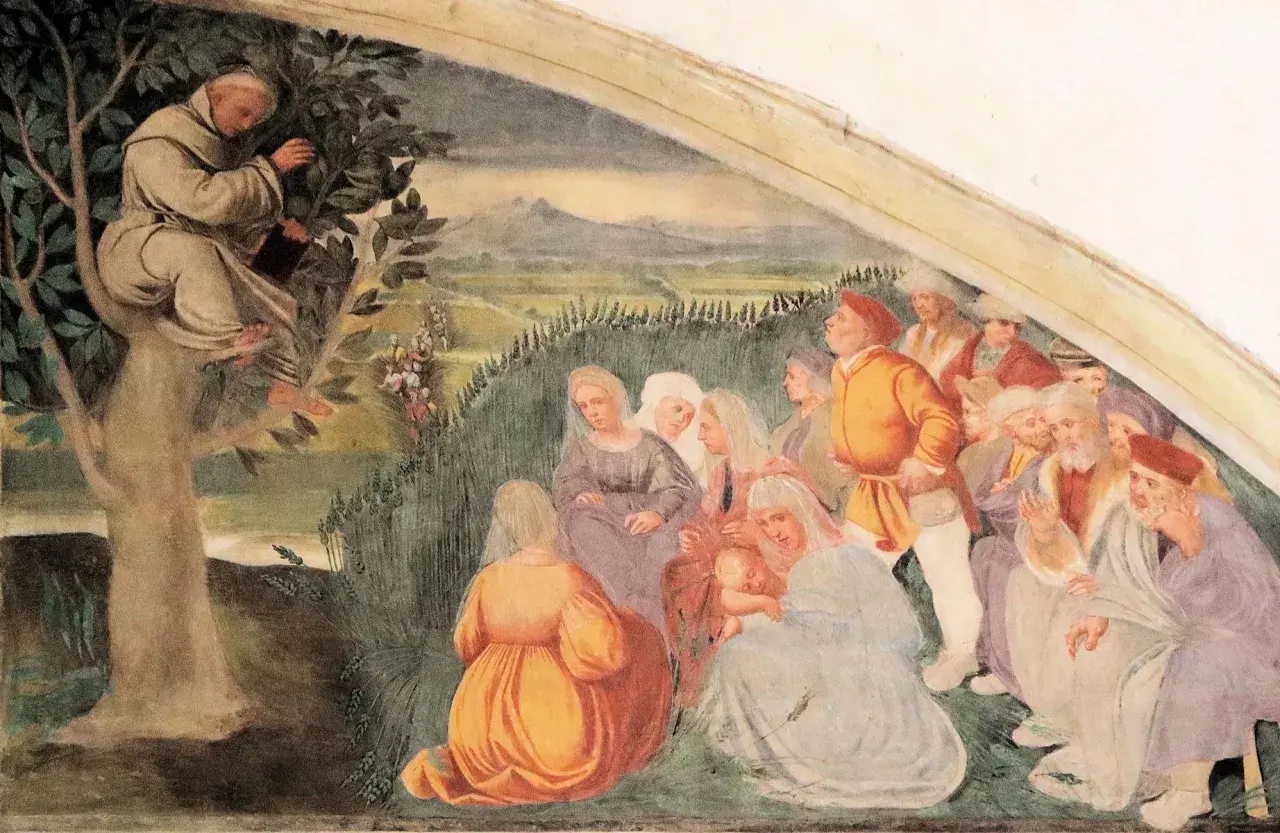 Der heilige Antonius predigt von einem Baum herab einer Gruppe von Menschen.
