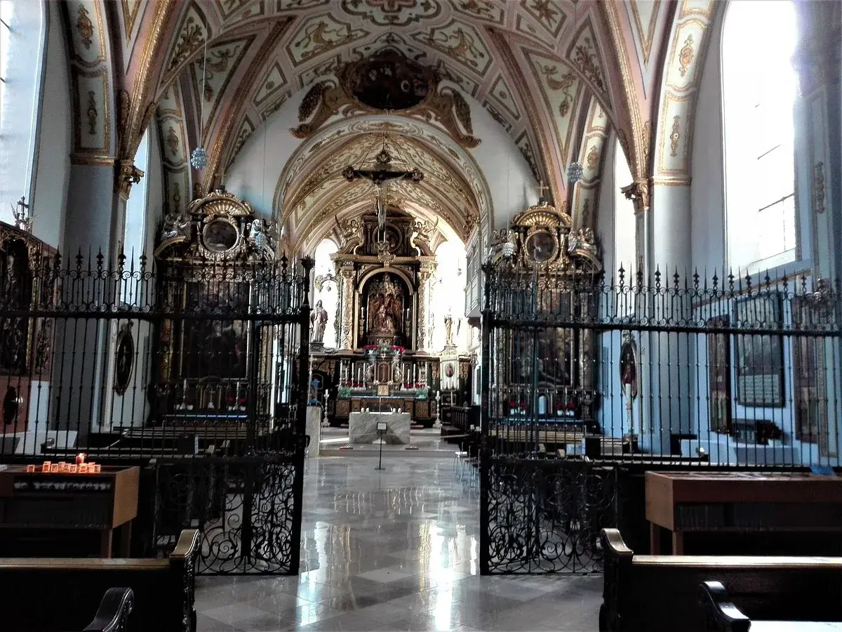 Prachtvoller Innenraum der Kirche Maria Ramersdorf mit kunstvollen Deckenmalereien, Altären und Gittern.